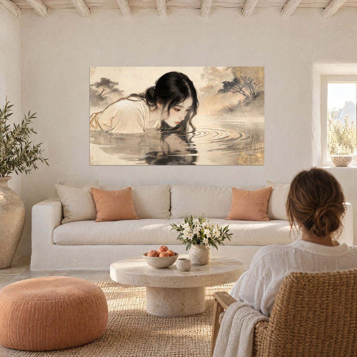 Wall art of a young woman with black hair leaning over water, cream and pale gold dress, above a sofa in a bright living room