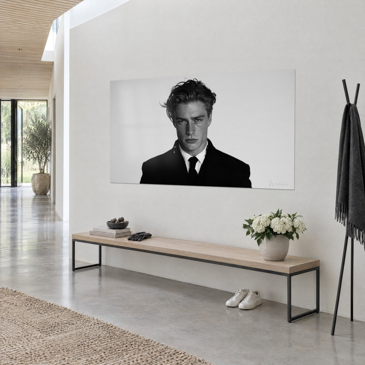 Wall art young model with freckles, wavy loose strands, black suit and white shirt, three-quarter view in an architect's house