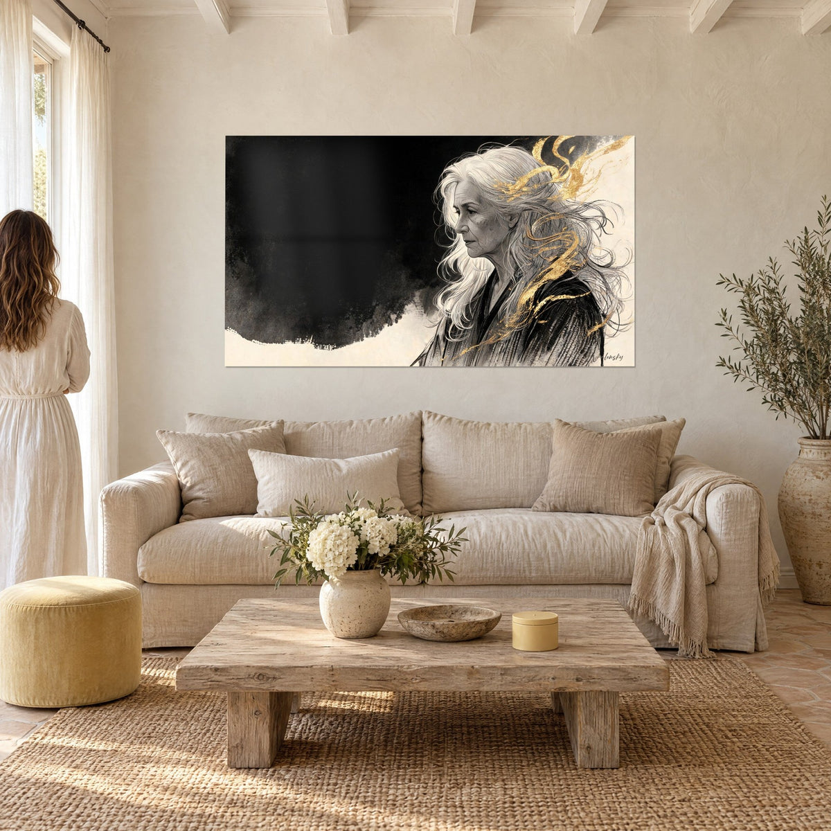 Wall art profile portrait of an elderly woman with long silver hair, golden filaments, black and cream background, above a sofa in a bright living room