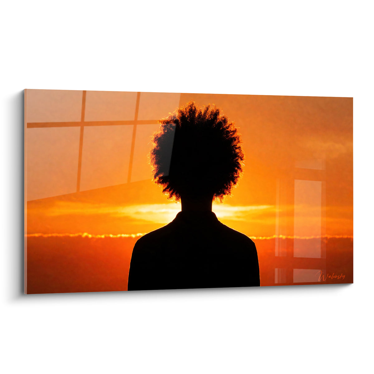 Wall art silhouette with a black afro hairstyle standing out against a glowing orange and golden sky