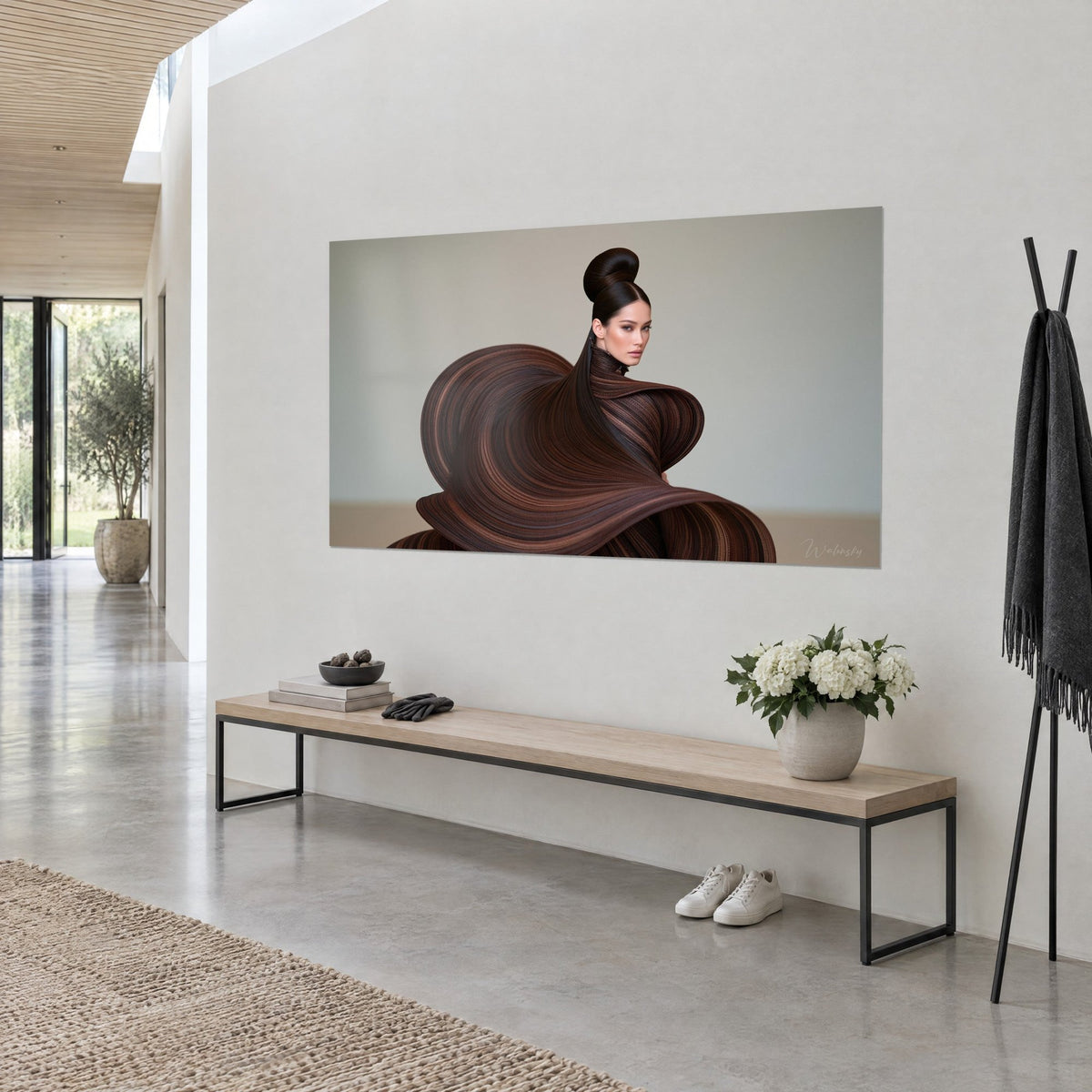 Wall art of a hair sculpture in chocolate and copper spirals on a pearl grey background, white wall, three-quarter view beside a wooden bench