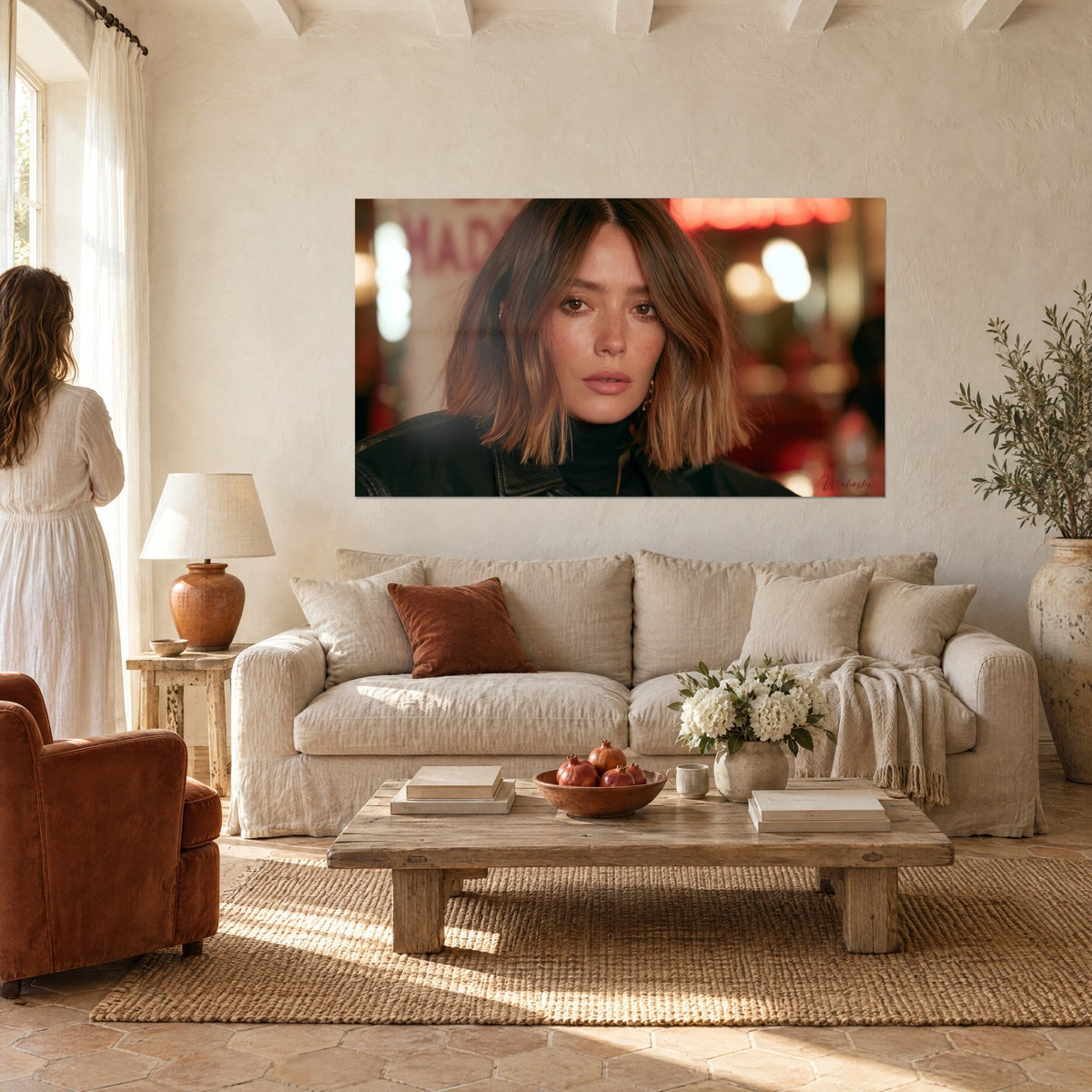 Wall art woman's face with hazel eyes and copper chestnut bob, black bomber jacket, blurred red neon lights, above a sofa in a bright living room