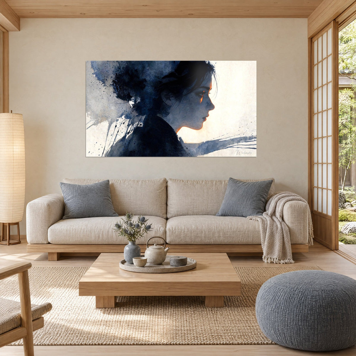 Wall art young brunette woman in profile, navy ink and orange glow on a cream background, above a sofa in a bright living room