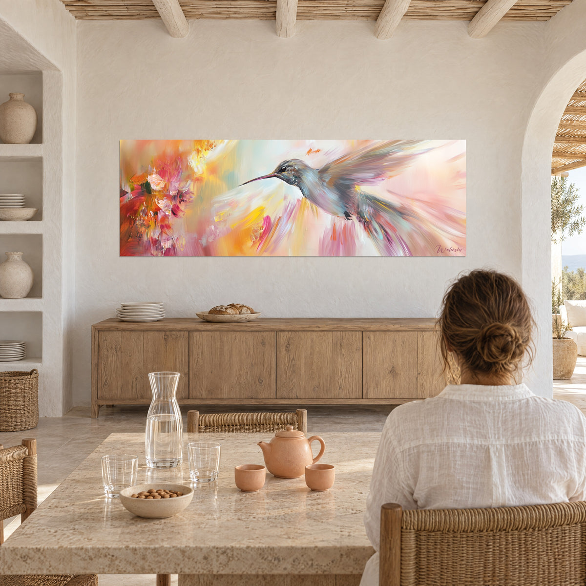 Wall art hummingbird hovering in front of red and pink flowers painted with a palette knife, ochre and mauve feathers, facing a set table