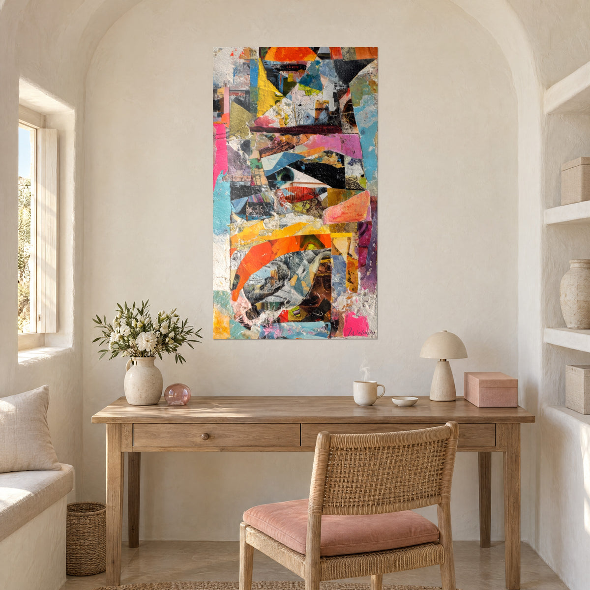 Cuadro recortes geométricos negros, amarillo dorado y rosa chicle, empastes blancos, pared abovedada encima de un escritorio de madera clara