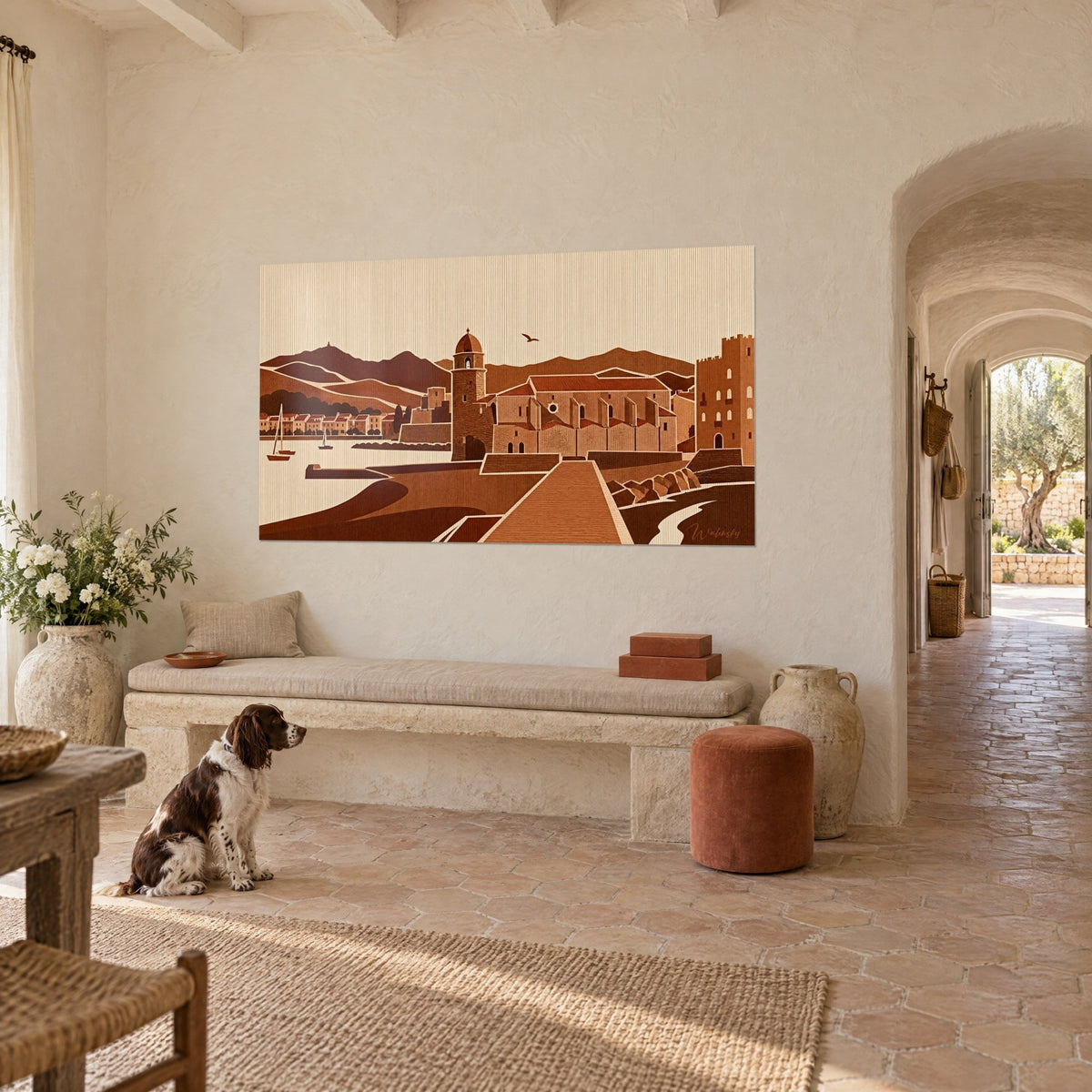 Wall art Catalan village by the water, ochre tower, streaked cream sky and sailboats, on the wall of a country house, with a spaniel sitting in front