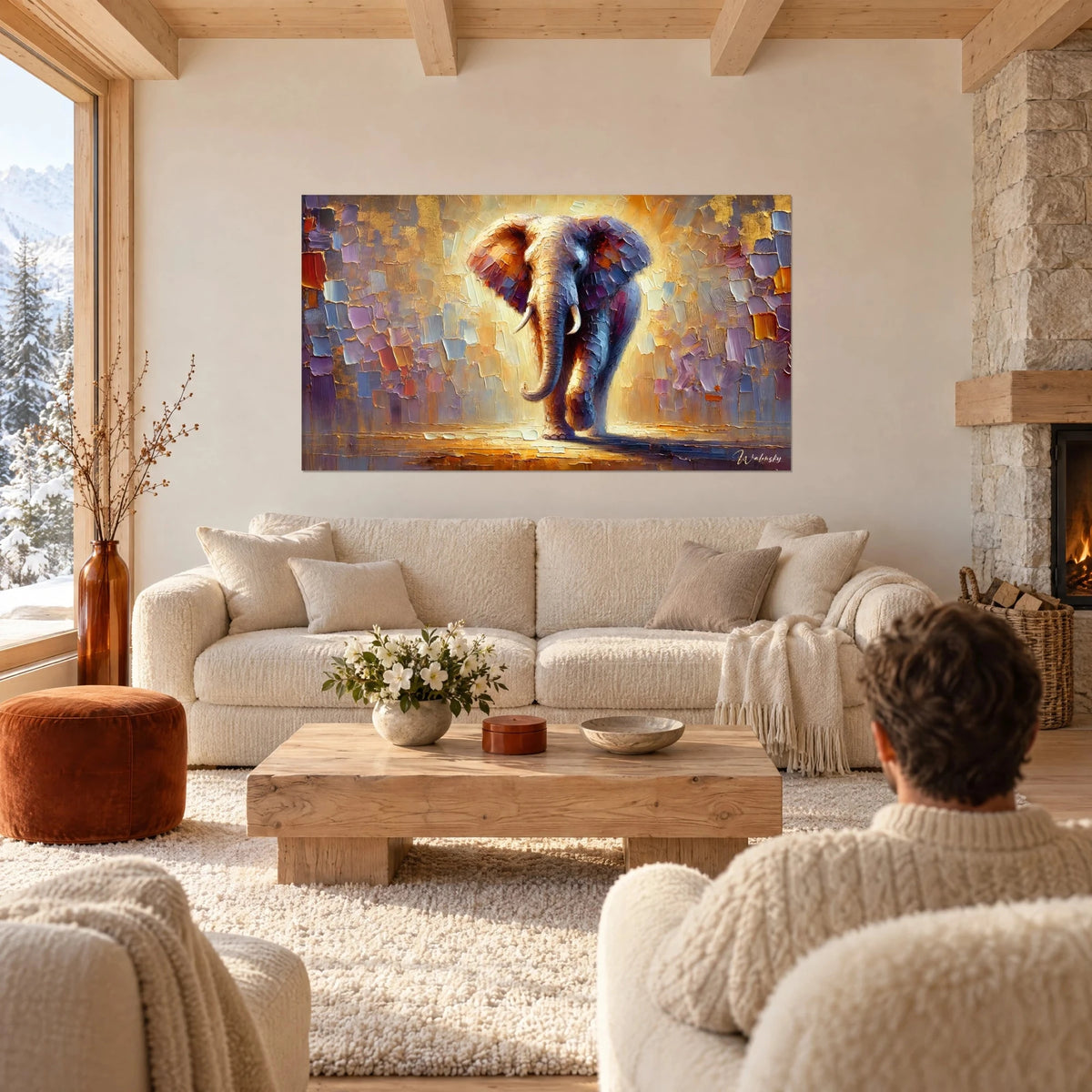 Wall art of a massive elephant with ivory tusks striding forward in golden and violet light, above a sofa in a bright living room