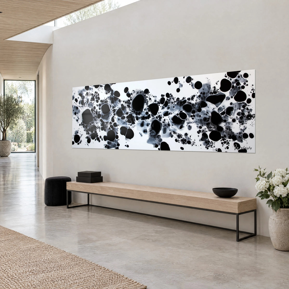 Wall art ink bubble galaxy in charcoal and pearl grey, fine splatters on a white background, sandy wall, wooden bench, three-quarter view