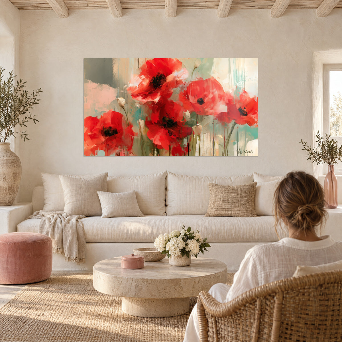 Wall art of scarlet poppies with crumpled petals on an almond green and powder pink background, above a sofa in a bright living room