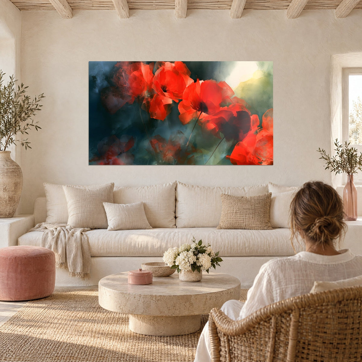 Quadro di papaveri scarlatti dai petali traslucidi su fondo grigio ardesia, donna di schiena sopra un divano in un soggiorno luminoso
