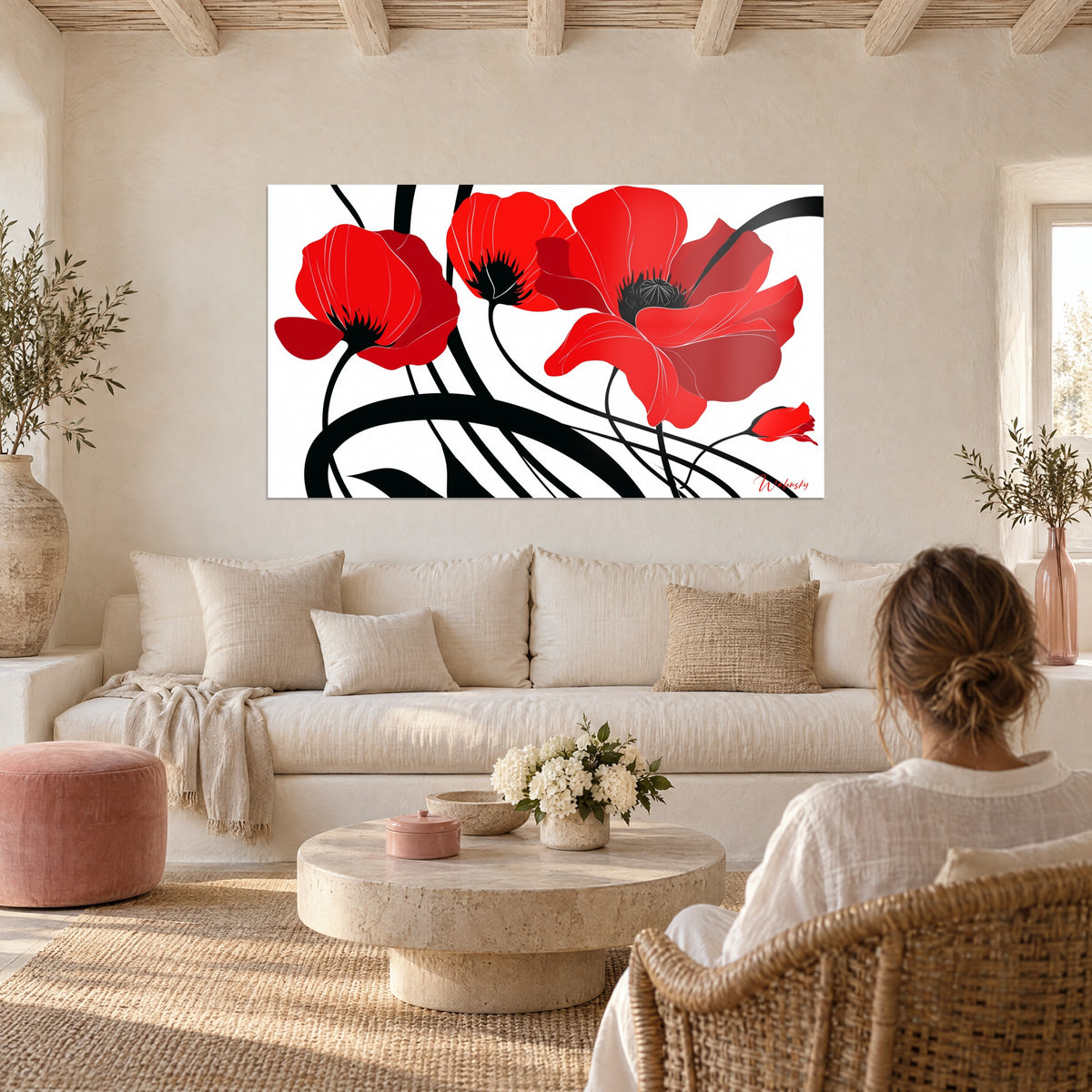 Tableau coquelicots écarlates aux cœurs noirs, tiges noires enlacées sur fond blanc, au-dessus d'un canapé dans un salon lumineux