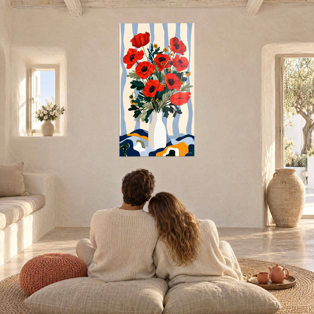 Wall art vermilion red poppy flowers and dark green foliage, couple seen from behind on cushions in a white living room