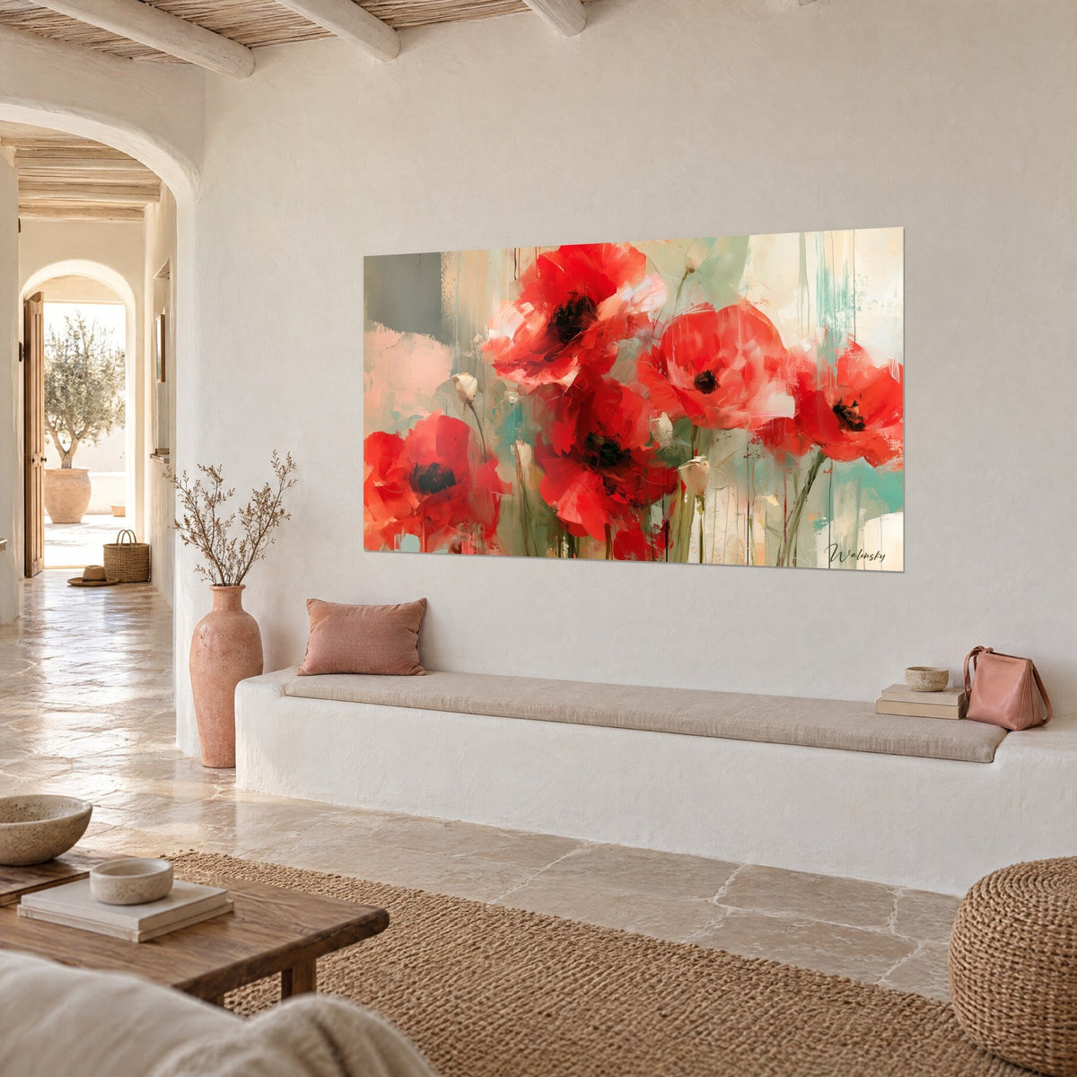 Wall art of vivid red poppies, black hearts and turquoise paint drips, hung at a three-quarter angle above a white plaster bench