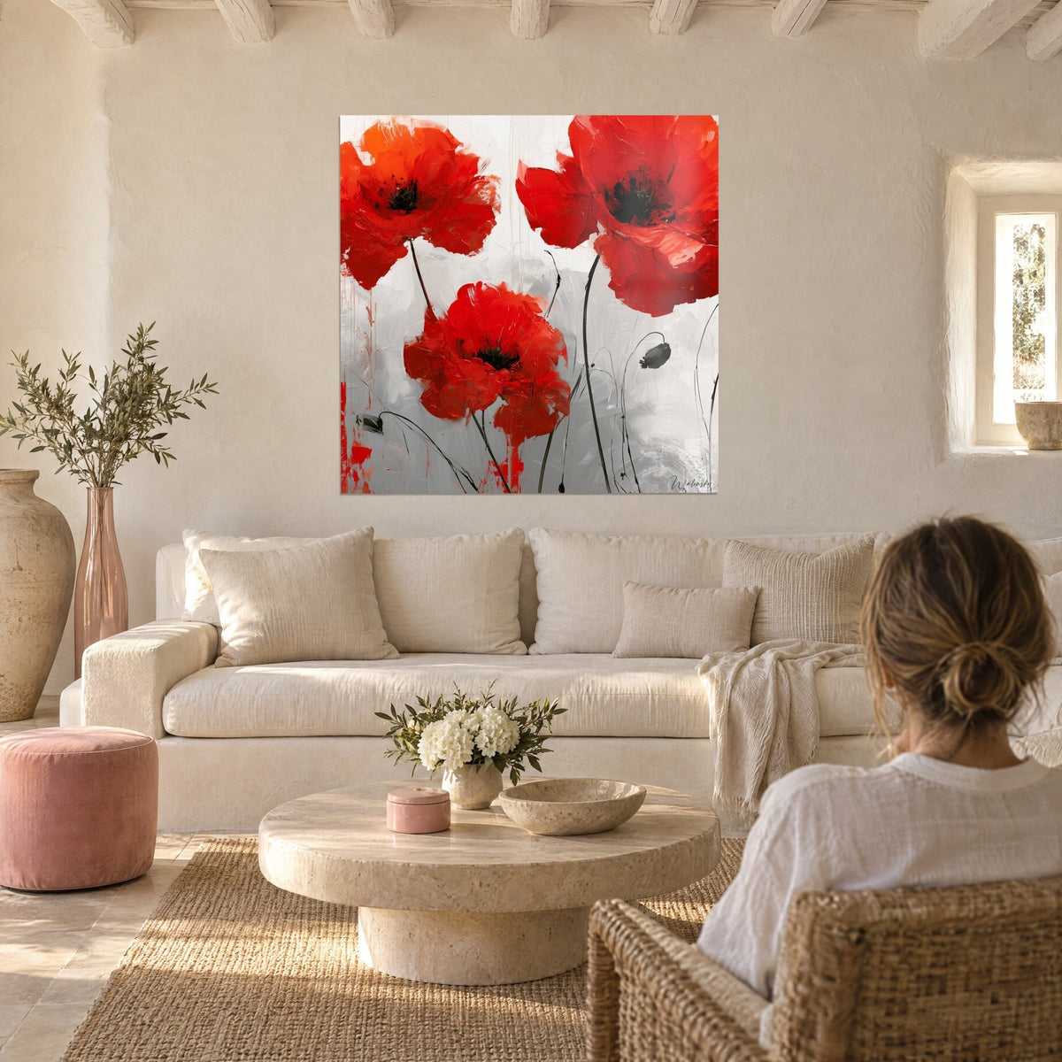 Tableau trois coquelicots écarlates aux pétales épais, cœurs noirs, fond gris perle, au-dessus d'un canapé dans un salon lumineux