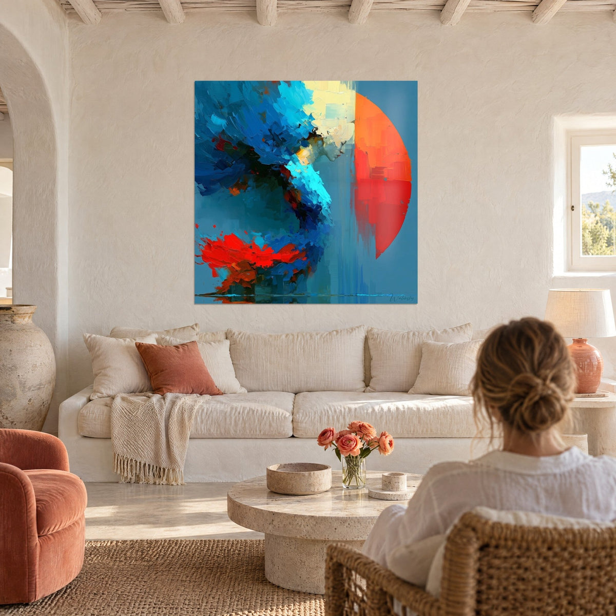 Tableau silhouette bleue penchée devant un disque orange et rouge, coups de couteau cobalt, au-dessus d'un canapé dans un salon lumineux