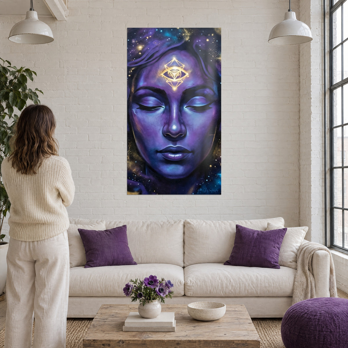 Wall art mystical face in purple and blue, golden eye in sacred geometry, woman seen from behind above a sofa in a bright living room