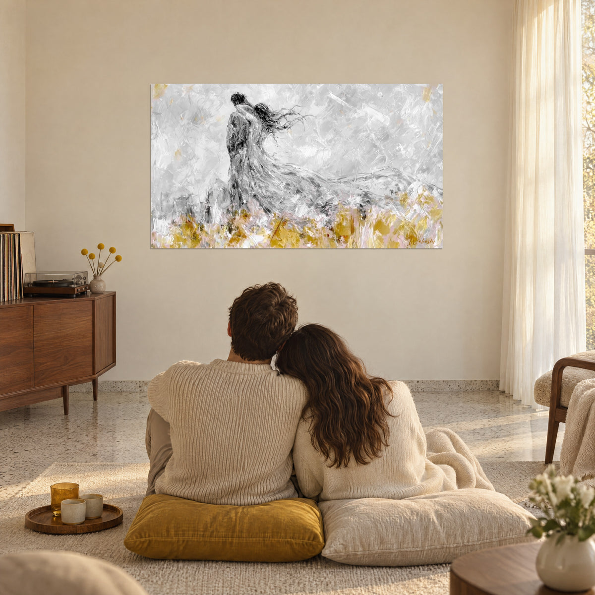 Wall art of a windswept romance, embracing man and woman, cloudy grey, saffron yellow and powder pink, facing a seated couple in the lounge