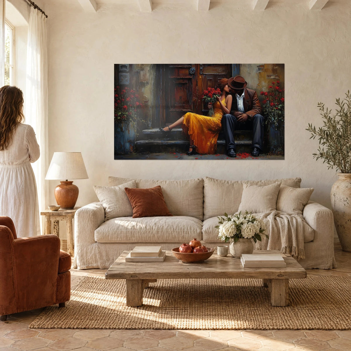 Wall art embracing couple on a front step, mustard yellow dress and bouquet of red roses, above a sofa in a bright living room