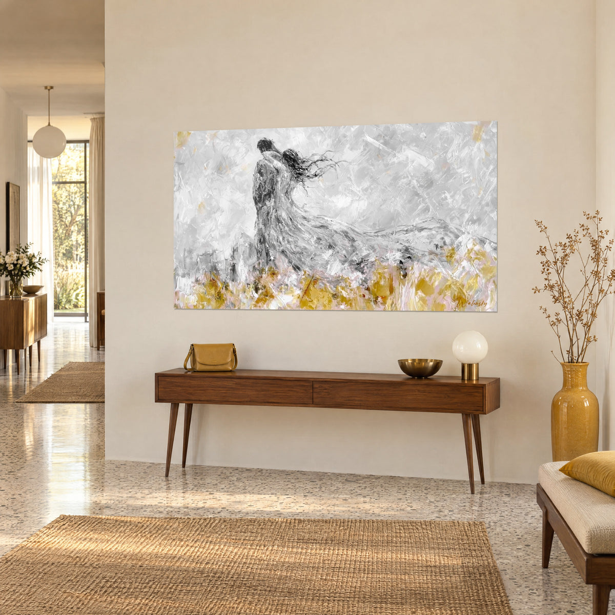 Wall art of an embrace in the wind, couple in profile, long silver-grey gown, mustard yellow field, above a wooden console in the entrance hall