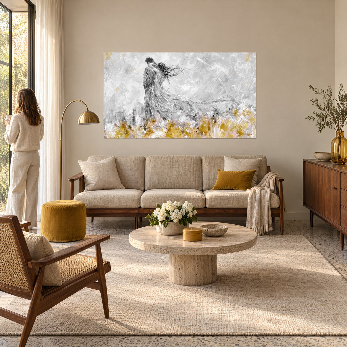 Wall art of intertwined lovers, grey dress billowing over golden grasses, soft pale pink touches, above a sofa in a bright living room
