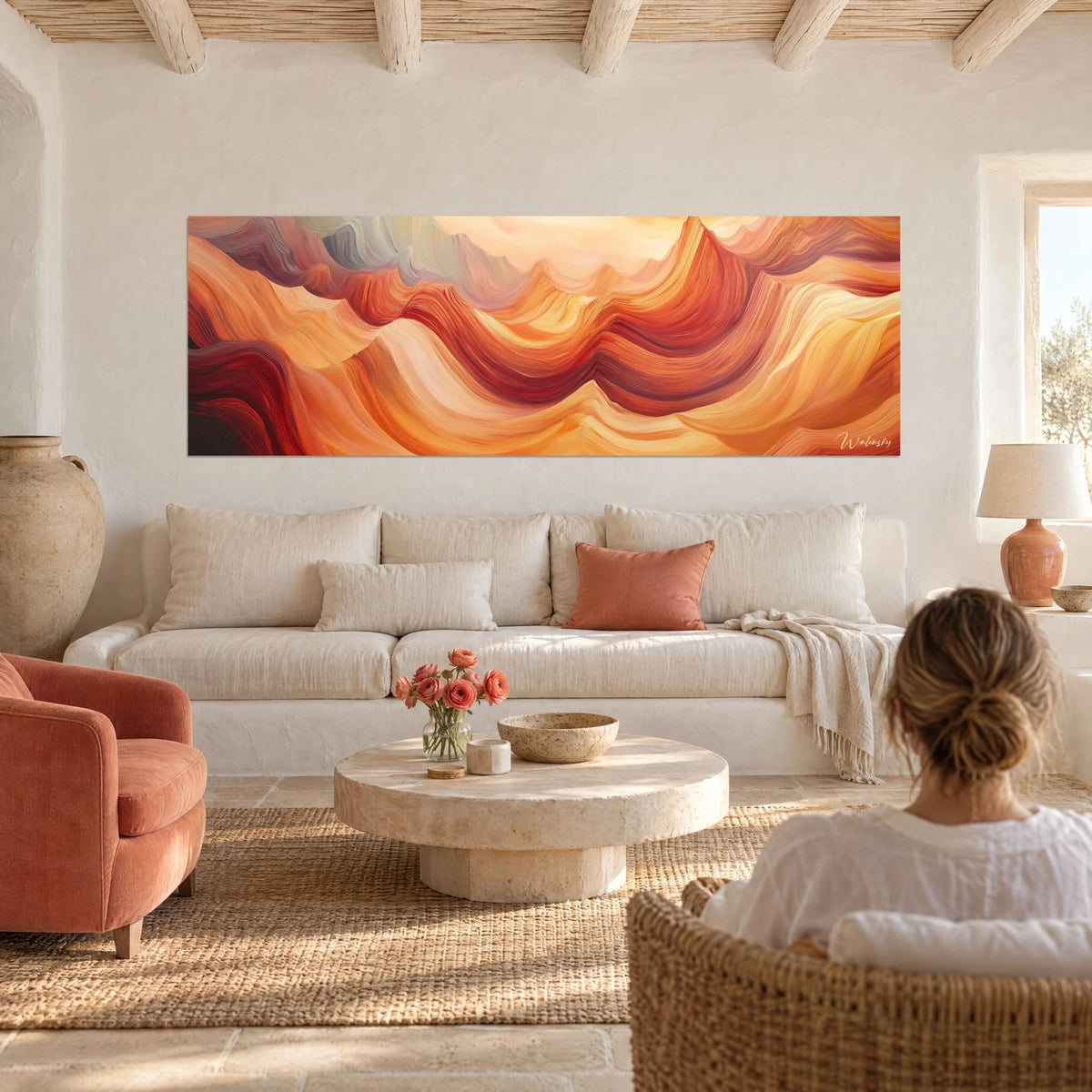 Wall art with wavy orange and brick-red dunes in thick brushstrokes, hung above a sofa in a bright living room