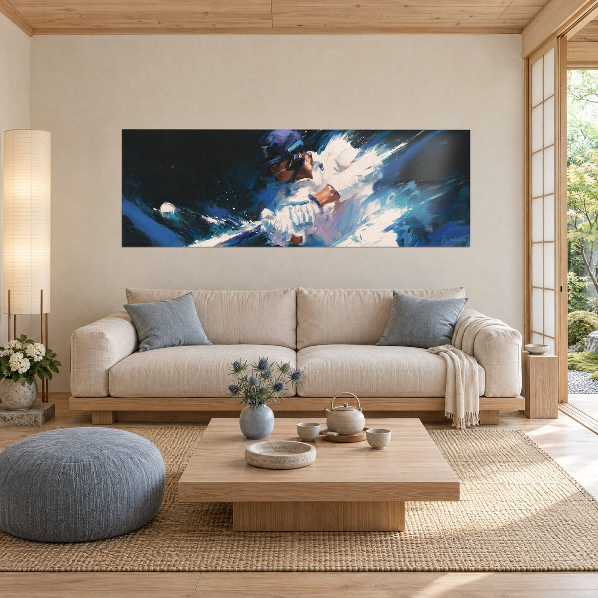 Wall art of a helmeted batter swinging his bat through the air, white clothing and midnight blue background, above a sofa in a bright living room