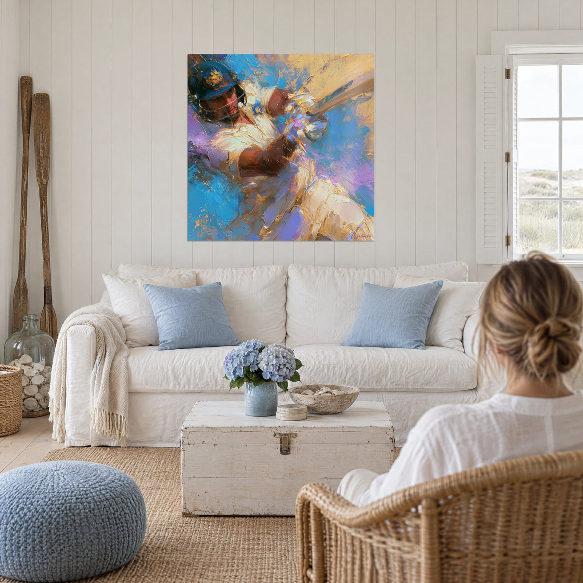 Wall art of a helmeted batsman in a sweeping swing, sky blue and mauve, golden thick paint, above a sofa in a bright living room