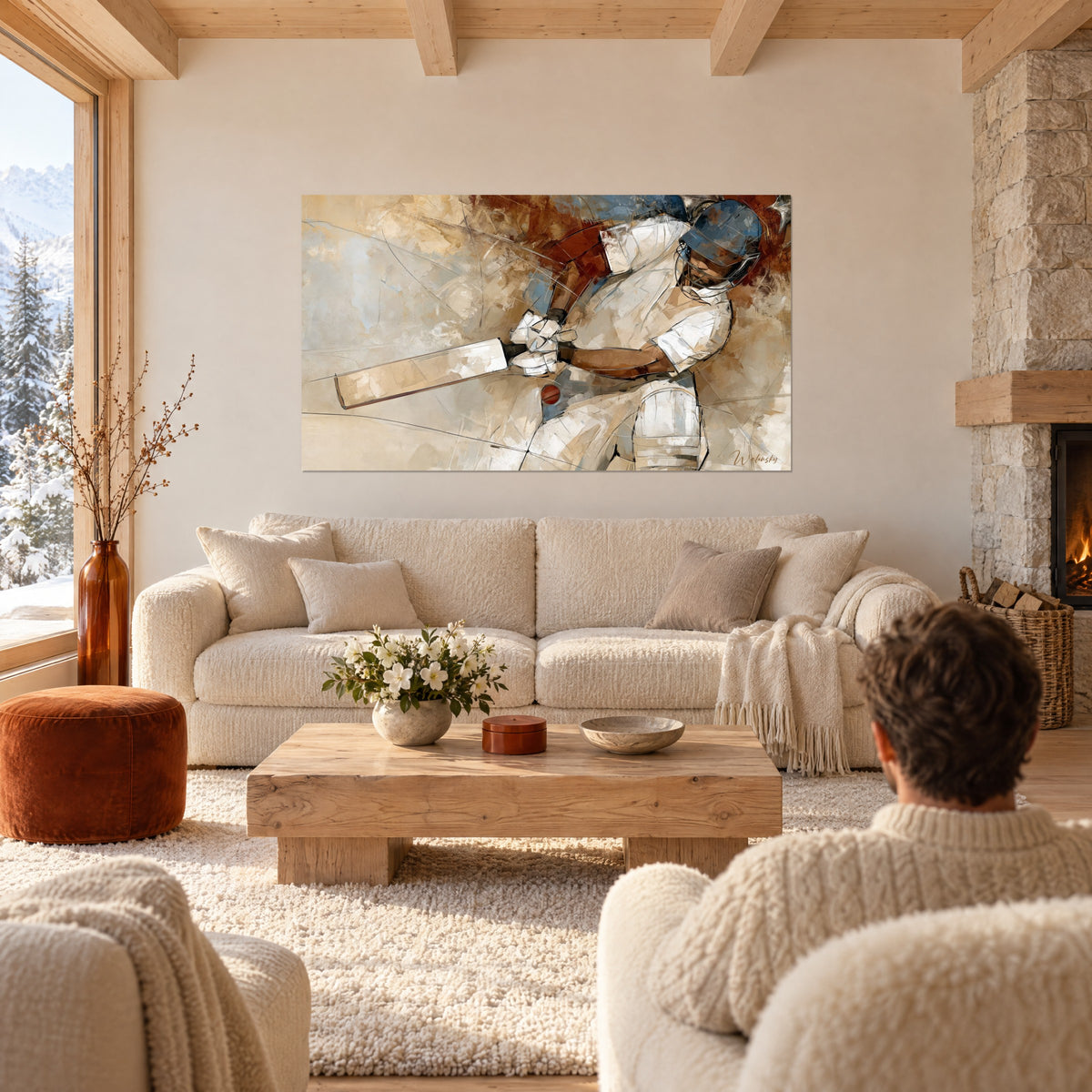 Wall art of a helmeted cricket player in steel blue and cream white, bats and sand-colored drips, above a sofa in a bright living room