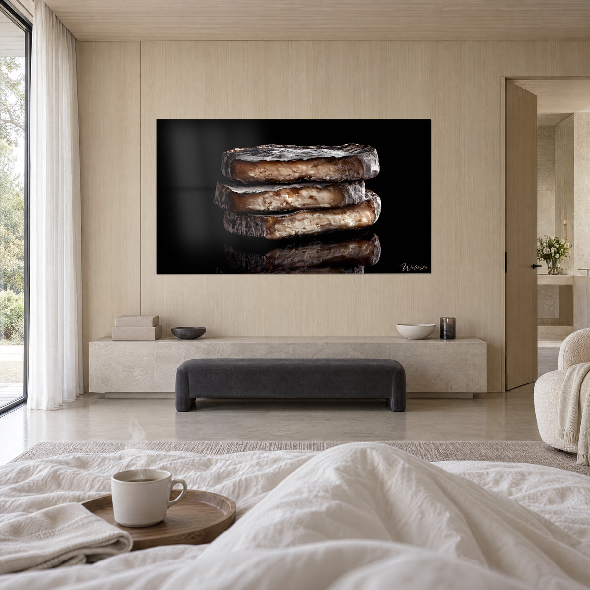 Wall art cheese slices with grey rind and speckled beige core, glossy black background, above a bed in a light bedroom, Walensky