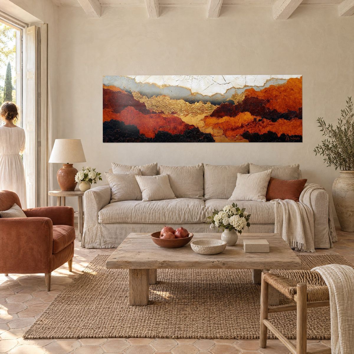 Wall art copper and gold ridges under a cracked white sky, person seen from behind, above a sofa in a bright living room