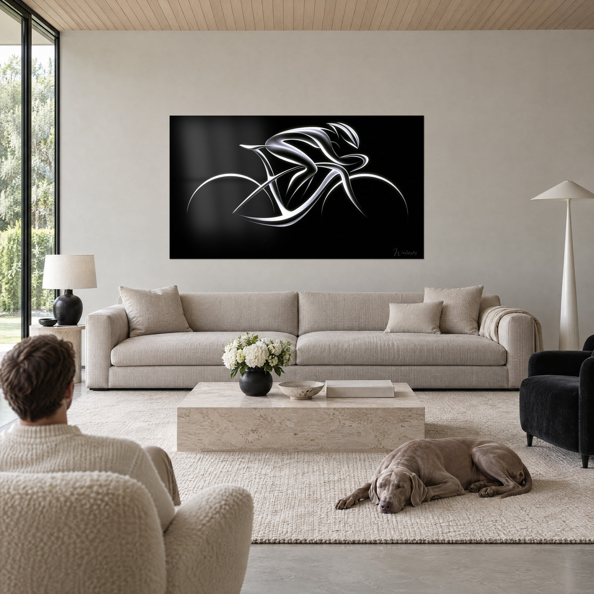 Wall art silver-lined cyclist on black background, man seen from behind and Weimaraner lying above a sofa in a bright living room