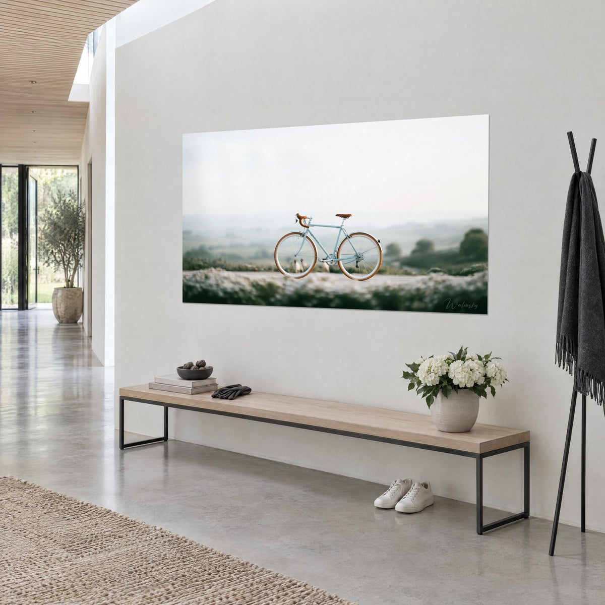 Wall art pale azure bicycle, honey-colored tires and handlebar tape, misty sage green hills, three-quarter view in a hallway