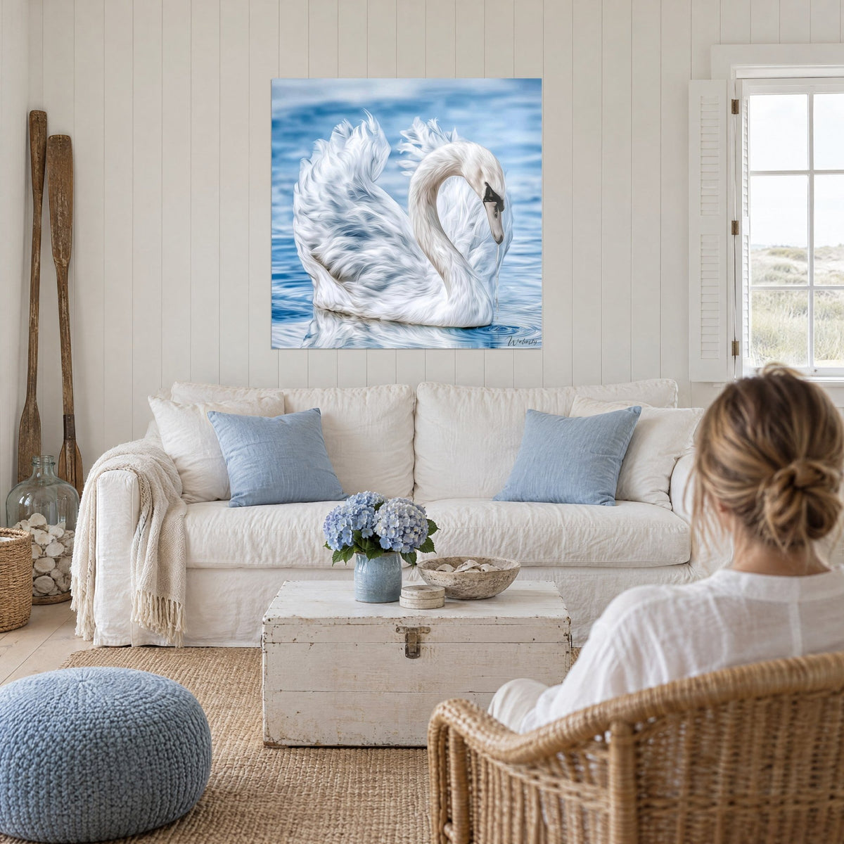 Quadro Cigno bianco con ali a volute su acqua azzurro cielo, goccia perlata sul becco, sopra un divano in un soggiorno luminoso
