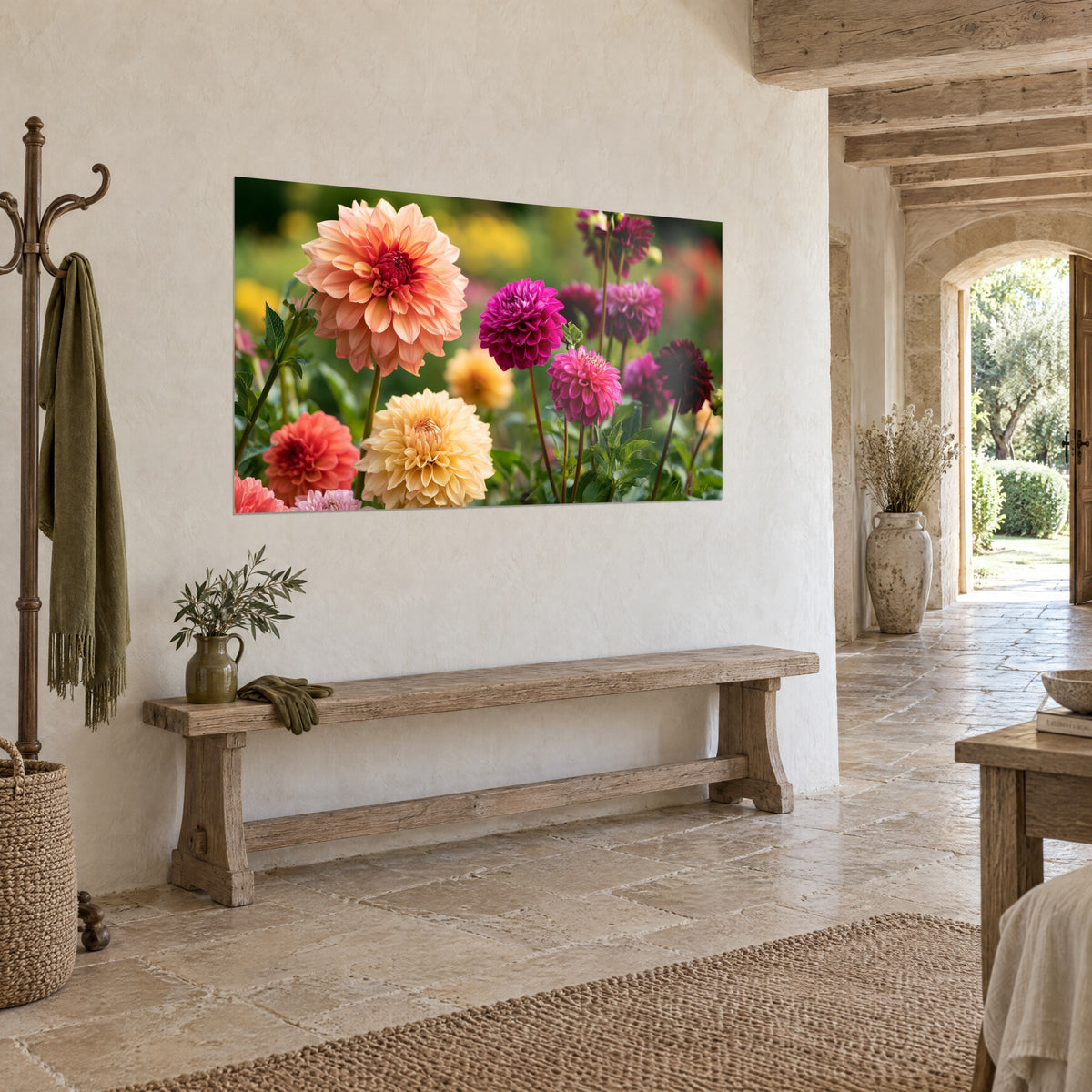 Wall art of a lush cluster of fuchsia, burgundy and cream pompom flowers against a blurred green background, stone wall and rustic wooden bench