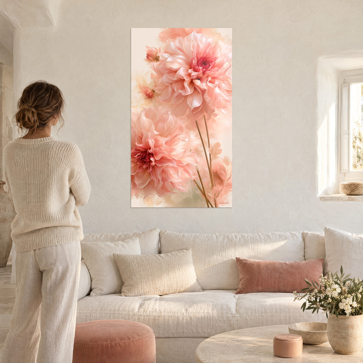 Wall art of a peach-pink dahlia with crumpled petals and a raspberry heart, hung above a sofa in a bright living room