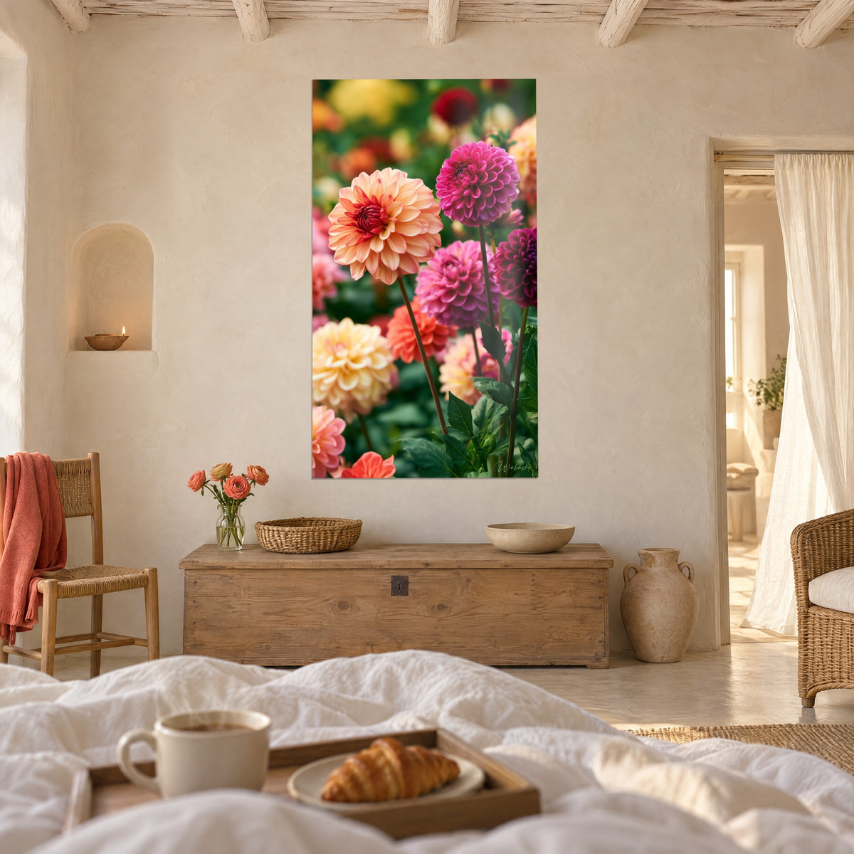 Wall art with a bouquet of apricot and plum-violet dahlias with green leaves, croissant platter, hung above a bed in a light bedroom