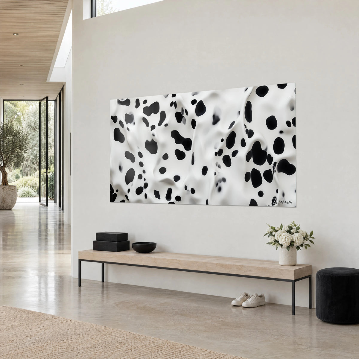 Tableau motif tacheté en relief, grosses taches noires sur plis de lait blanc, vu de trois quarts au-dessus d'un banc en bois clair