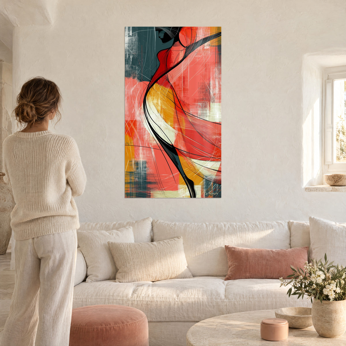 Cuadro de una bailarina estilizada con curvas rojo coral y ocre, velo negro arremolinado, colgado sobre un sofá en un salón luminoso