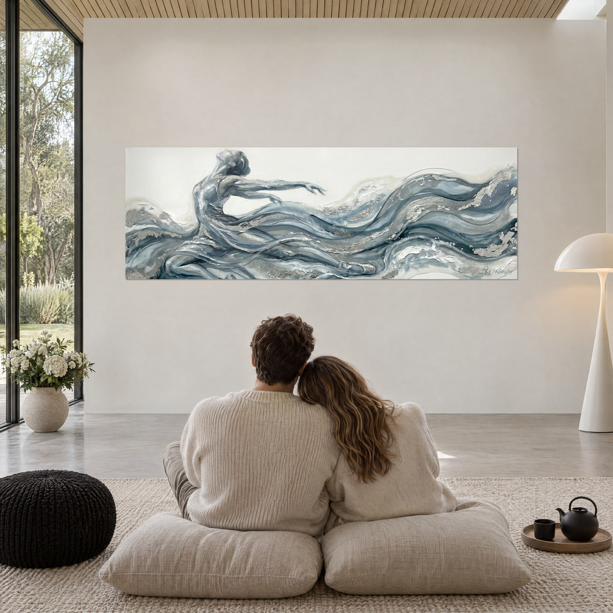 Wall art aquatic movement of a dancer, blue-grey currents and off-white, silver sequins, facing a couple seated on the floor