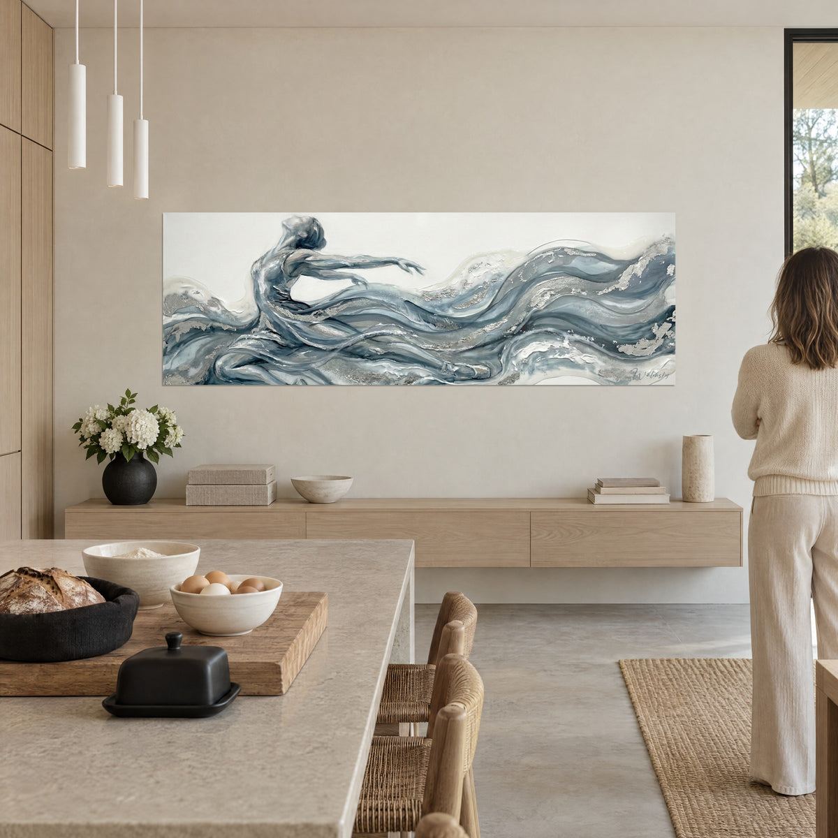 Wall art dance figure with pearl grey and glacier blue paint waves, silver touches, cream beige wall of an open kitchen
