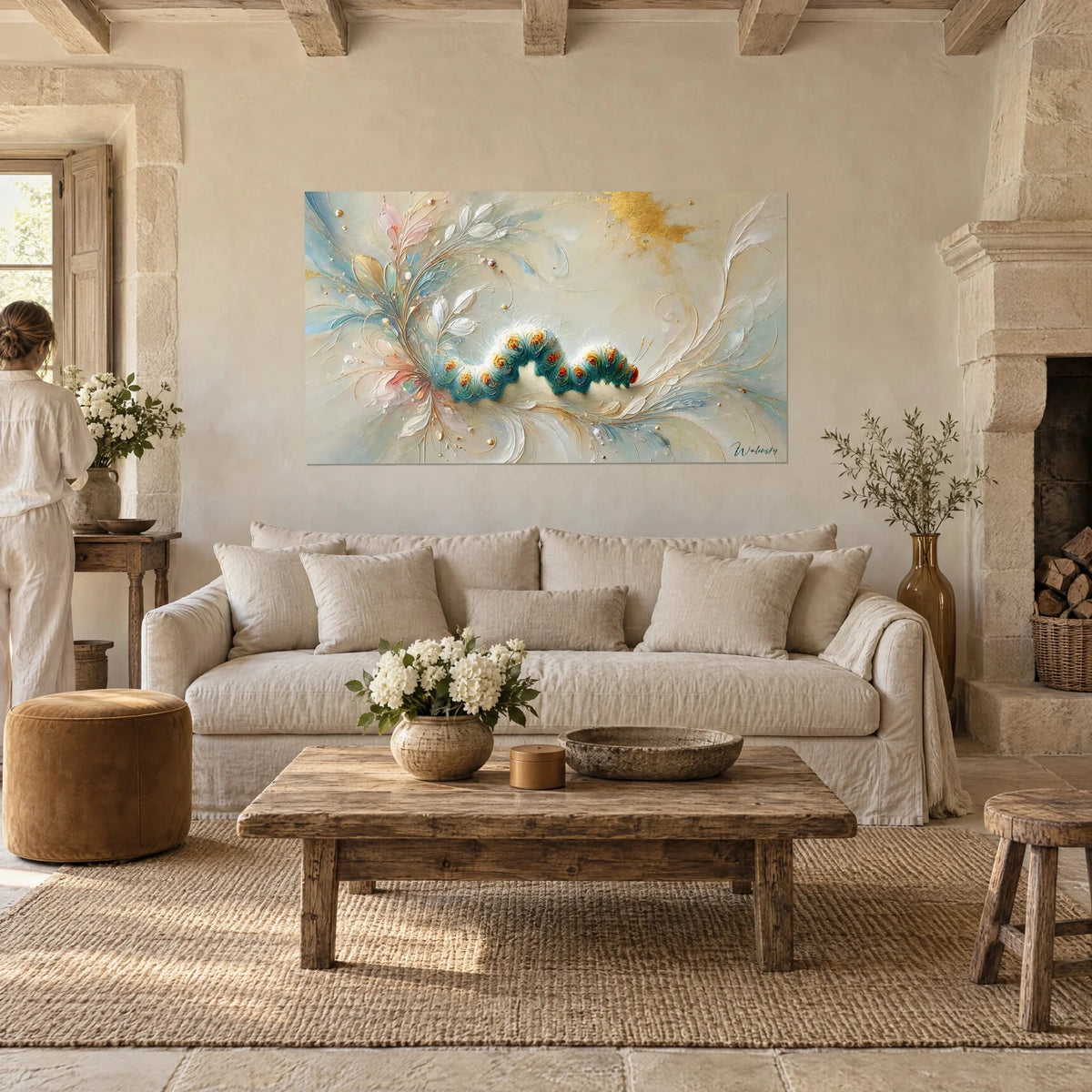 Wall art turquoise caterpillar dotted with orange pearls, coiled in ivory and gold swirls, woman seen from behind above a sofa in a bright living room
