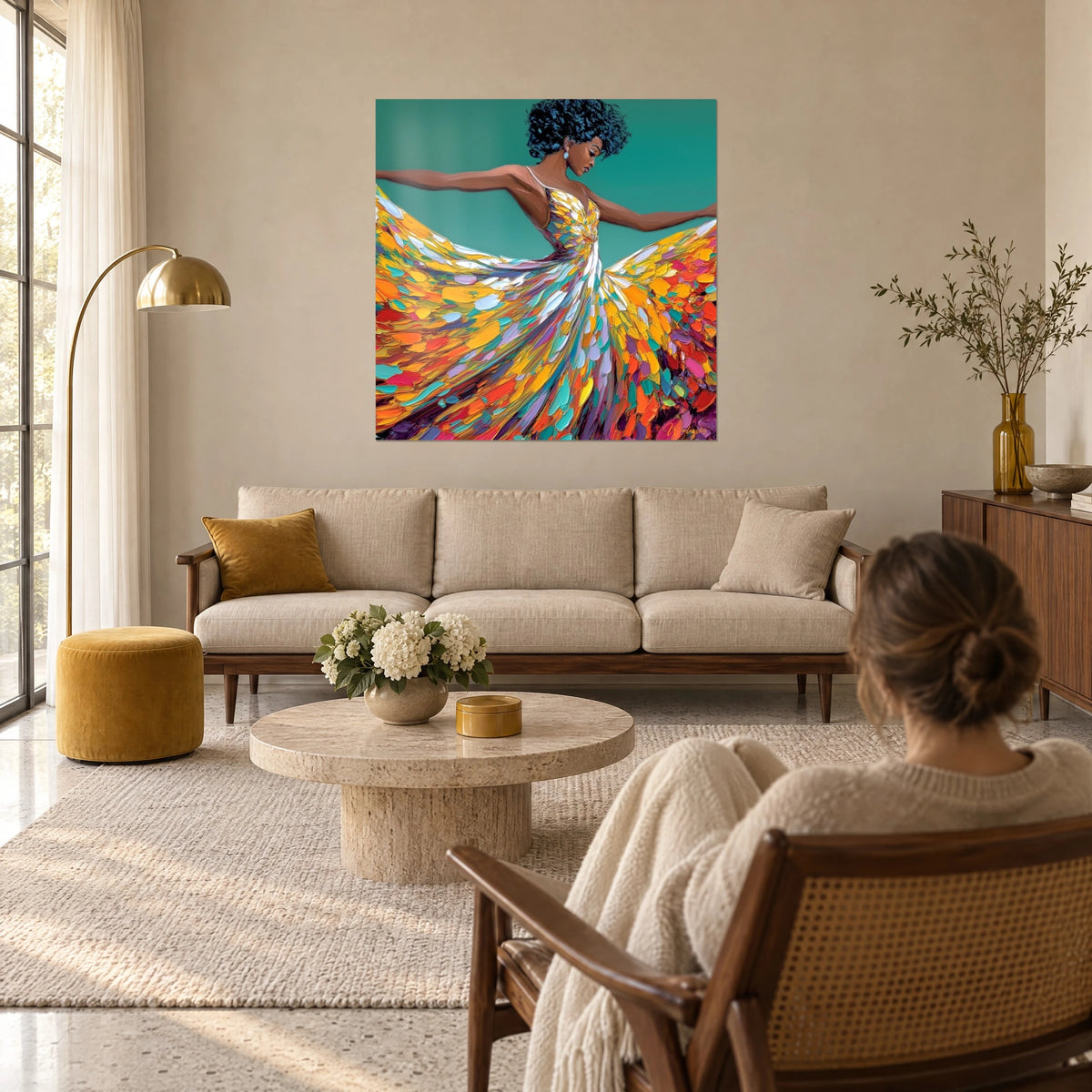 Wall art dancer with open arms, saffron yellow and coral dress in palette-knife strokes, emerald green background, above a sofa in a bright living room