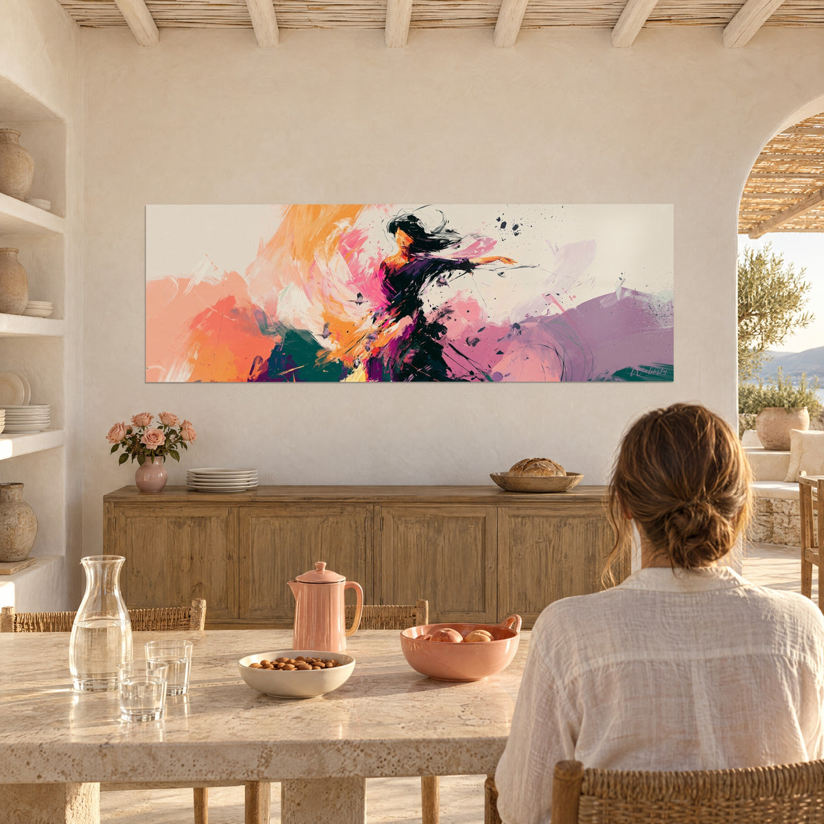 Wall art of a painted ballerina, black strands blowing in the wind, coral and peach streaks, white dining room, arch framing the olive tree