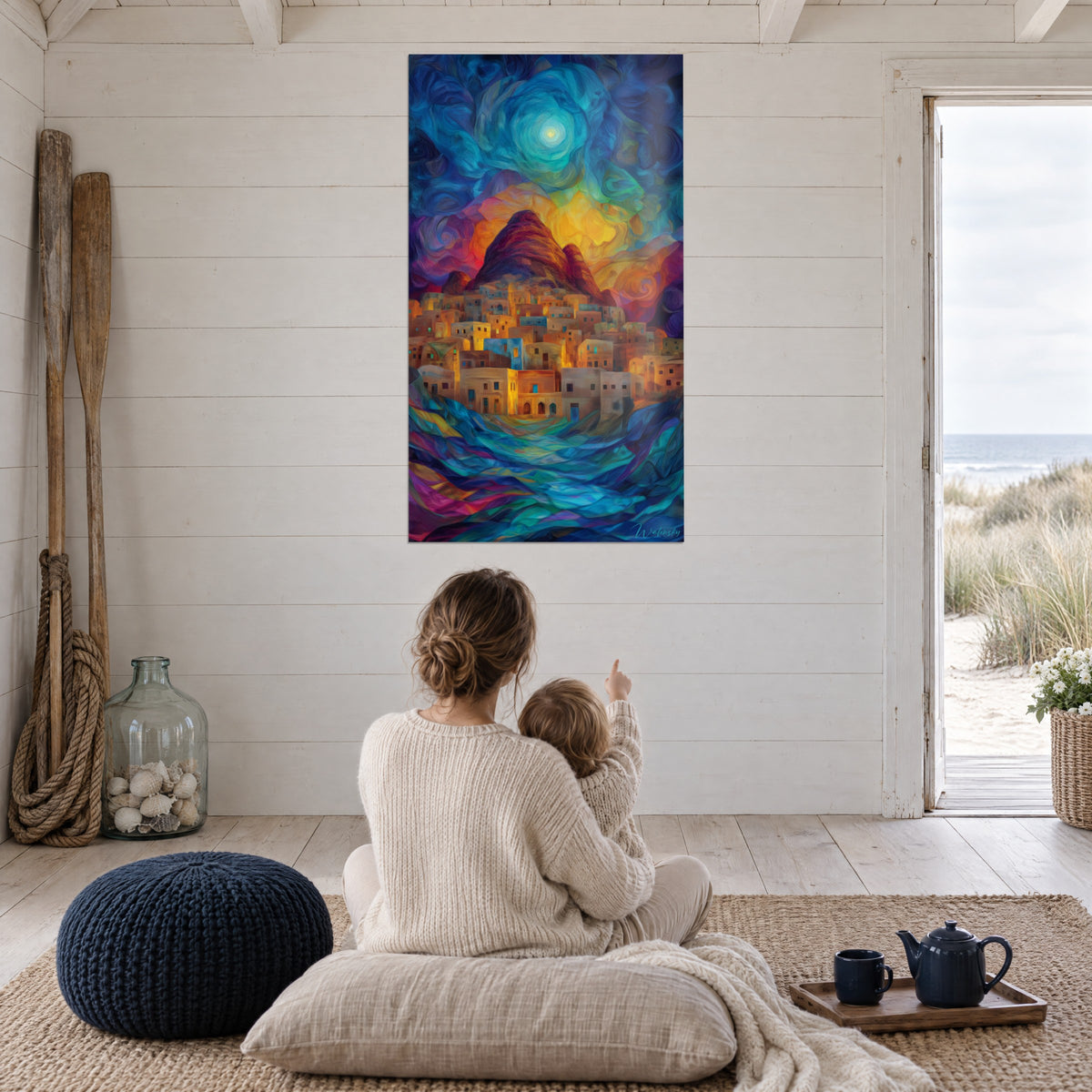 Wall art of a golden stone hamlet under a bright yellow sun and indigo clouds, mother and baby seen from behind, on a white plank wall facing the sea