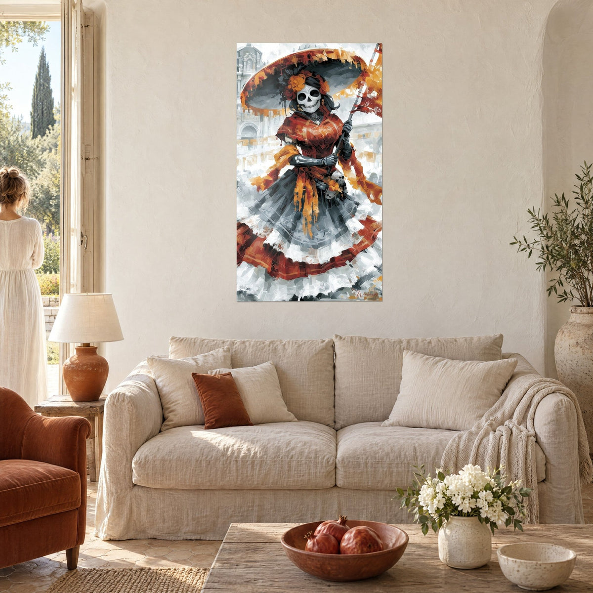 Wall art Catrina skeleton under an orange sombrero, red and grey dress, raised flag, above a sofa in a bright living room