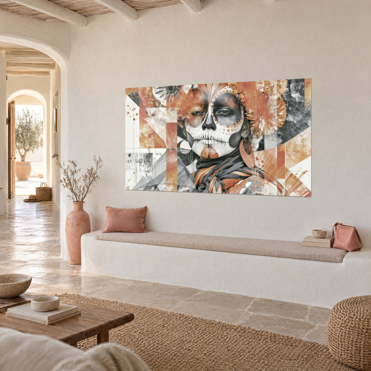 Wall art calavera portrait with grey eye sockets and orange-dotted cheekbones, whitewashed wall, stone bench and pink jug