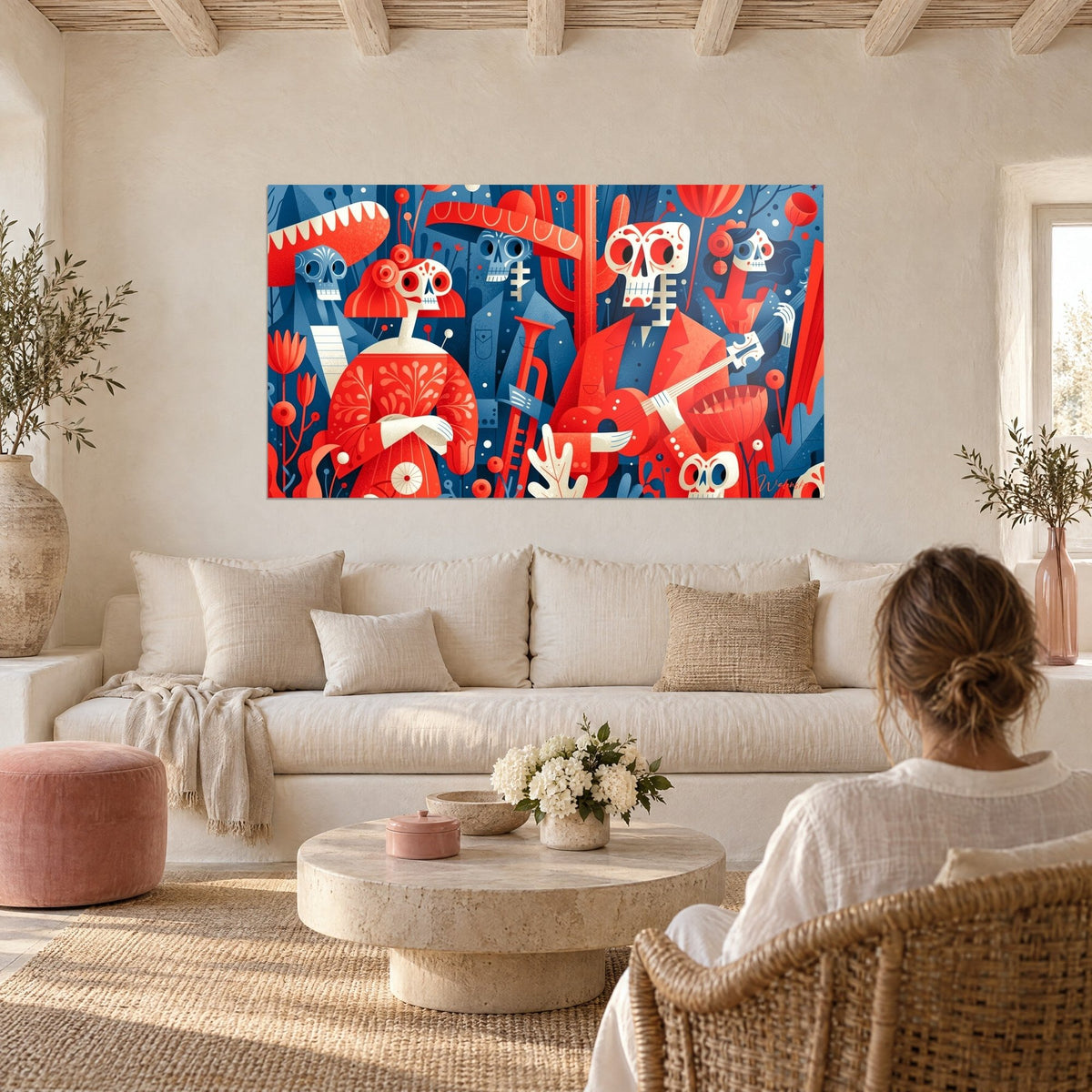 Wall art musician skeletons in bright red and navy blue, trumpet and guitar, above a sofa in a bright living room