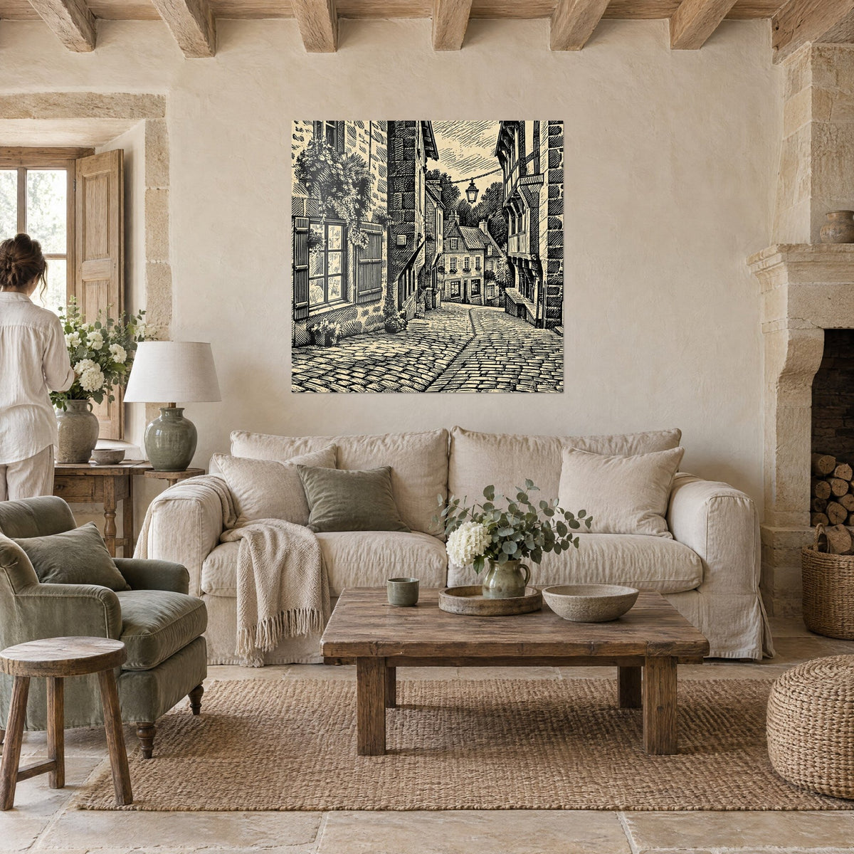 Wall art engraved cobblestone alley in black and cream, half-timbered houses and hanging lantern, above a sofa in a bright living room