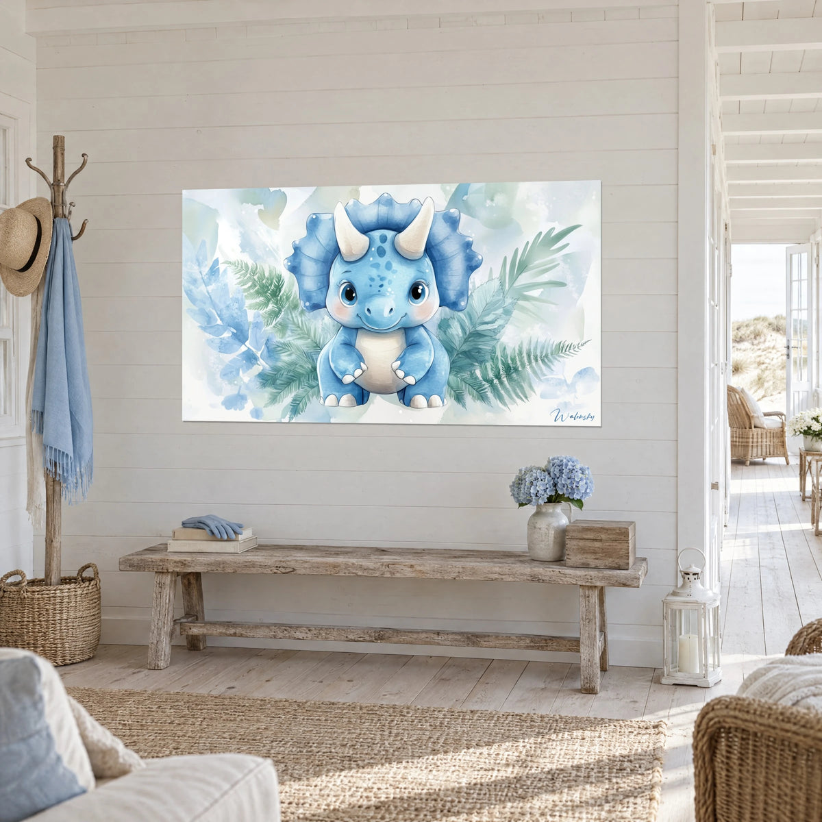 Wall art small smiling dinosaur with a blue frill and ivory horns, green ferns, hung in a seaside living room