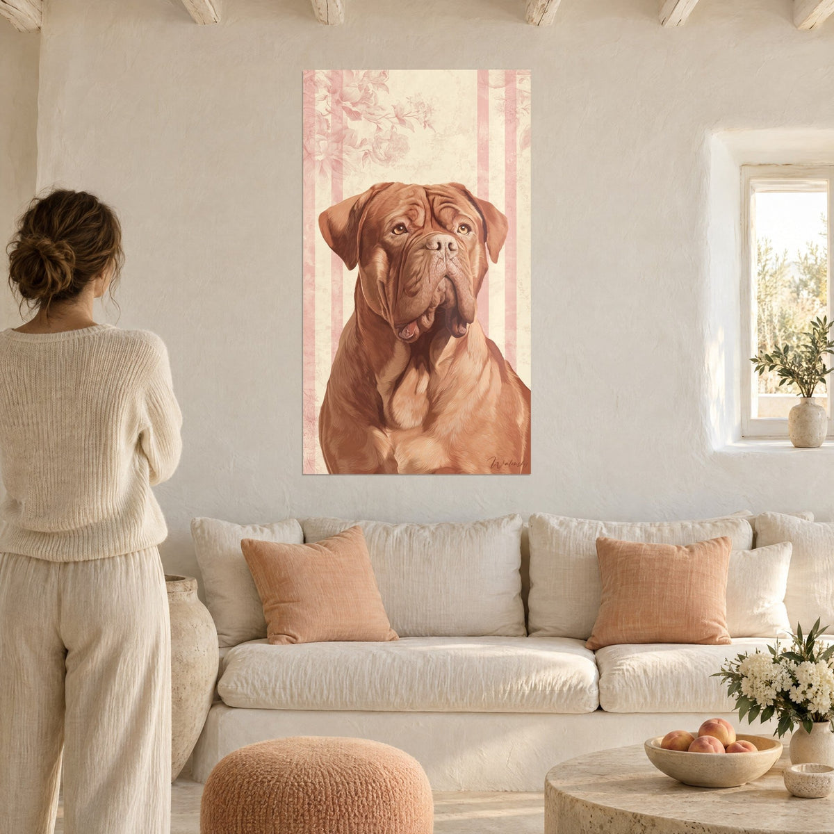 Wall art Bordeaux mastiff with a tawny coat, cream background striped in pale pink, viewed by a woman from behind, above a sofa in a bright living room